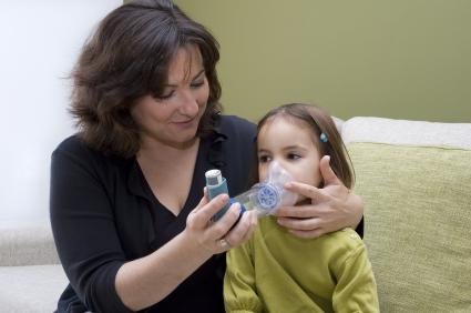 child with asthma assisted by her mother